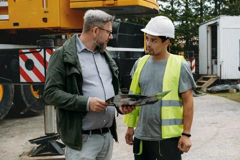 Foreman and client discussion work on construction site Architect with builder 写真素材