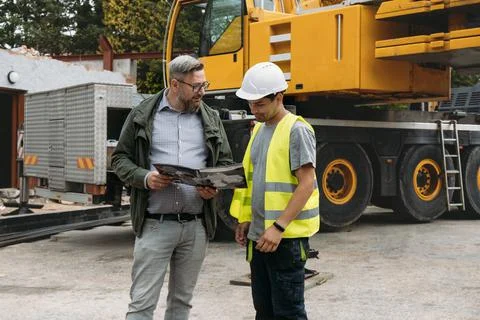 Foreman and client discussion work on construction site Architect with builder Stock Photos