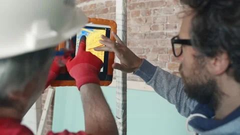 Foreman and contractor using infrared camera on tablet pc Stock Footage 133638411