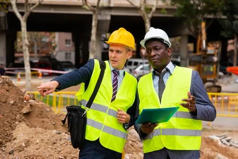 Foreman and engineer having conversation about road paving Stock Photos