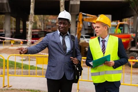 Foreman and engineer talking about road repairing Stock Photos