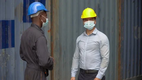 Foreman and engineer worker man wearing protective face mask bump elbows inst Stock Footage 154683672