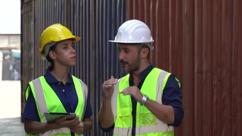Foreman and harbor worker discussion and using digital tablet checking list Stock Footage 157716626