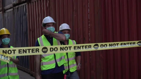 Foreman and harbor worker taking  off face mask walking out of forbidden area Stock Footage 157716607