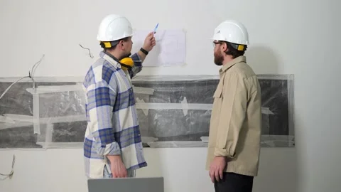 The foreman and the owner of the object discuss the project next to the drawing Stock Footage 236176960