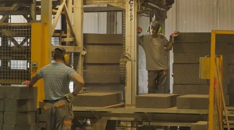 Foreman and worker doing his job at concrete blocks factory Stock Footage