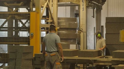 Foreman and worker doing his job at concrete blocks factory Stock Footage
