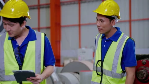 Foreman are walking to inspect the operation of machines in the factory Stock Footage 175777948