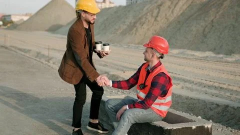 Foreman bring drinks for professional builder on site Stock Photos