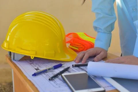 Foreman checking blueprint paper work building estate construction Stock Photos