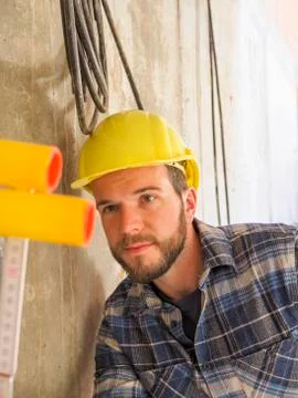 Foreman checking construction work with pocket rule Stock Photos