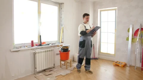 Foreman checking the progress of work in a renovated room Stock Footage 312671393