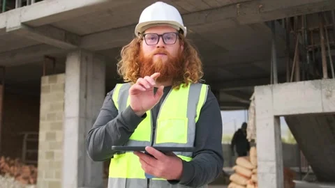 Foreman construction site moves finger on virtual screen panel, copyspace, link Stock Footage 274479754
