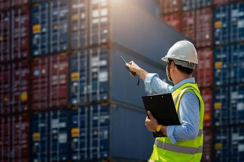 Foreman control loading Containers box to truck Stock Photos