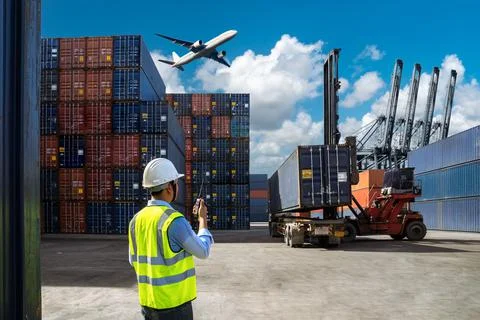 Foreman control loading Containers box to truck Stock Photos