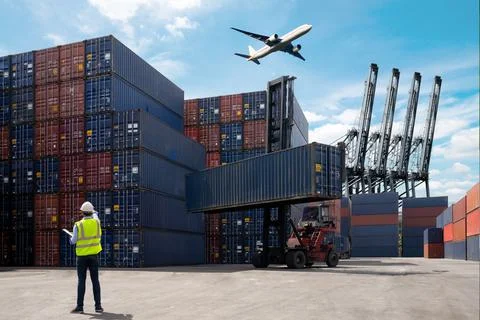 Foreman control loading Containers box to truck Stock Photos