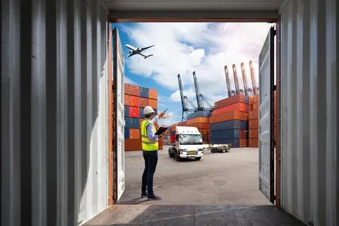 Foreman control loading Containers box to truck Stock Photos