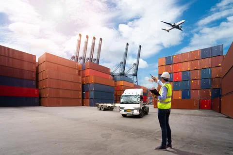 Foreman control loading Containers box to truck Stock Photos