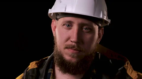 Foreman engineer straightens white helmet and looks at the camera. The real boss Stock Footage 139725180