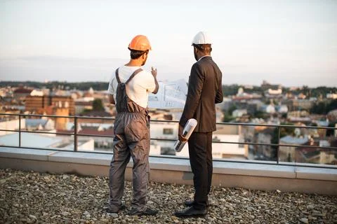 Foreman explaining drawings to international engineer 스톡 사진