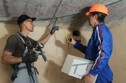 Foreman gives instructions to workers Stock Photos