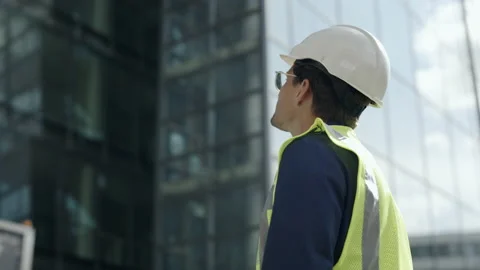 Foreman in helmet controlling building process outdoors Stock Footage 167226709