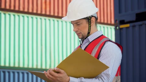 Foreman holding document file check list inventory and loading Containers b.. Stock Footage 241713144