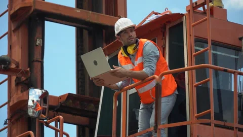 Foreman holding laptop computer checking loading Containers box on cabin cran Stock Footage 140275111