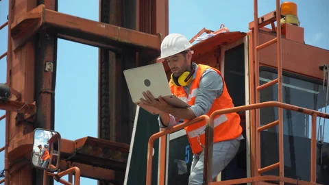 Foreman holding laptop computer checking loading Containers box on cabin cran Stock Footage 145206027