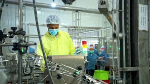 The foreman is inspecting the can conveyor line and recording data Stock Footage 339013450