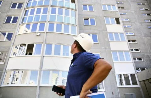 Foreman, inspector examines the house for defects Stock Photos