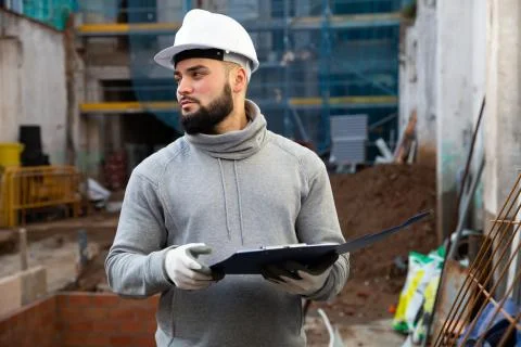 Foreman making task list during building works Stock Photos