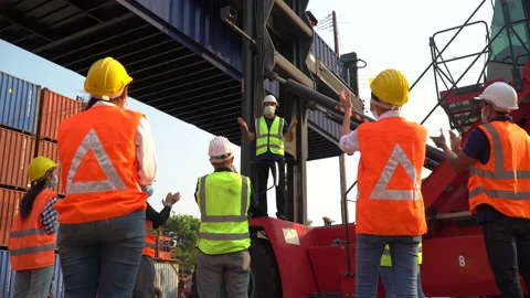 Foreman manager standing on forklift excited and raised hand up to success in Stock Footage 157716958
