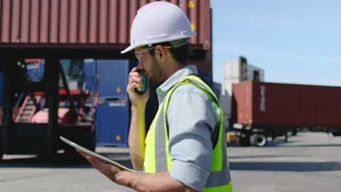 Foreman or cargo container worker walk along and in front of crane container Stock-Footage 146429185