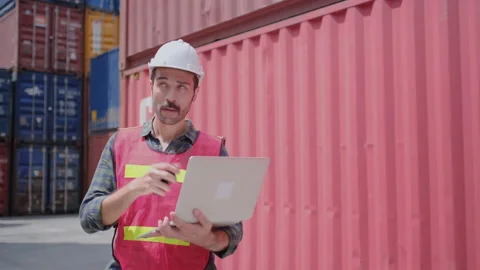 Foreman or engineer cargo worker use walkie talkie radio contact with team Stock Footage 146712149