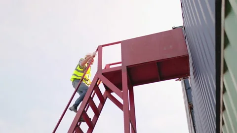 Foreman or factory container worker climb staircase to top over container tank Stock-Footage 146480008