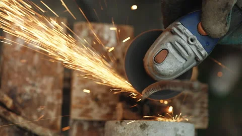 Foreman in protective gloves using grinder cutting metal tube. Engineer working Stock Footage 202205797