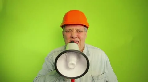 Foreman shouting into a megaphone on a green background Stock Footage 18955908