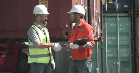 Foreman sign an import export document for male engineer. They shaking hands. Stock Footage 200987141