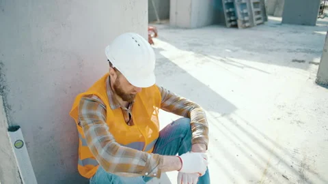 Foreman sitting outdoors and feeling tired after overwork Video stock 253589413