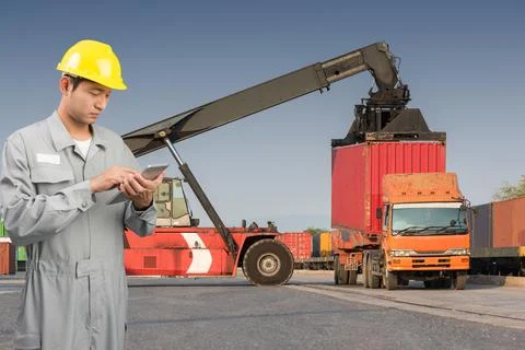 Foreman stand check tablet on front forklift loading Containers box Stock Photos