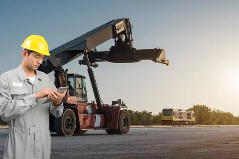 Foreman stand check tablet on front forklift loading Containers box Stock Photos