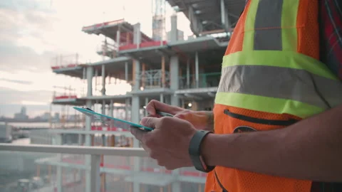 Foreman taking notes and overseeing a construction job Stock Footage 220747509