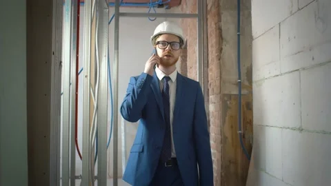 Foreman talking on phone with contractor standing on construction site Stock Footage 133637531