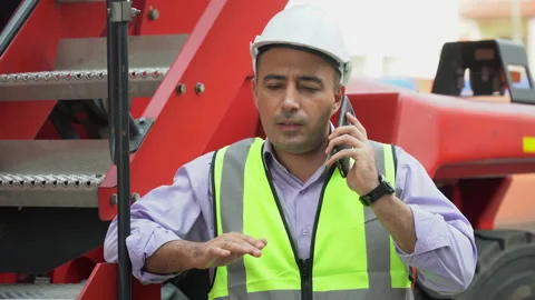 Foreman talking on smartphone control loading Containers box on forklift exci Stock Footage 154693875