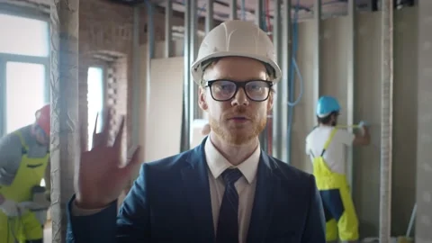 Foreman talking via video chat with owner on construction site Stock Footage 133639019