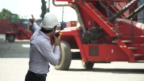 Foreman talking on the walkie-talkie control loading Containers box at wareho Stock Footage 139095422