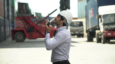 Foreman talking on the walkie-talkie control loading Containers box at wareho Stock Footage 139095557