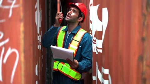 Foreman use walkie talkie to communicate and control staff in container area. Stock Footage 233281936