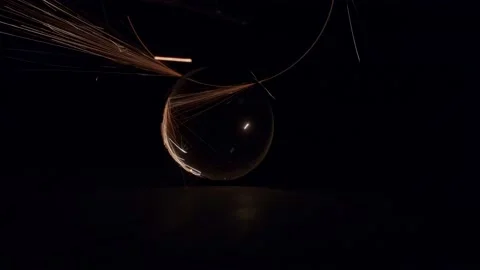 The foreman uses an angle grinder and cuts the stainless steel pipe in the dark Stock Footage 152415431